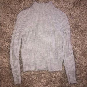 A turtleneck, gray sweater